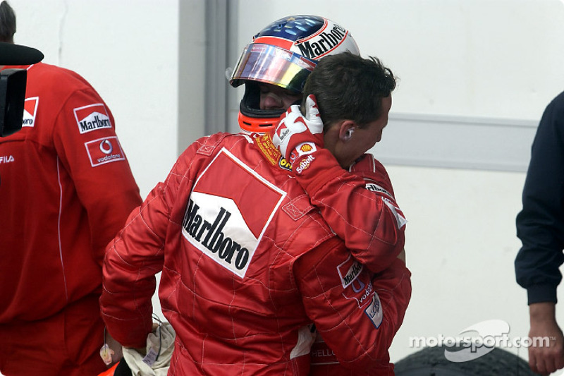 Michael Schumacher being congratulated by Rubens Barrichello