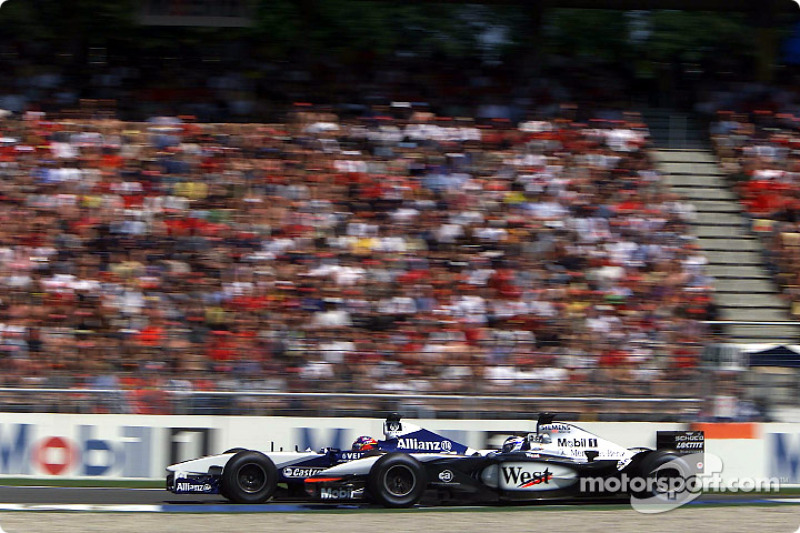 Kimi Raikkonen and Juan Pablo Montoya battling