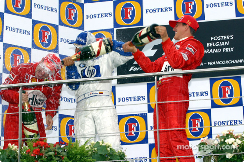 The podium: champagne for Michael Schumacher, Rubens Barrichello and Juan Pablo Montoya