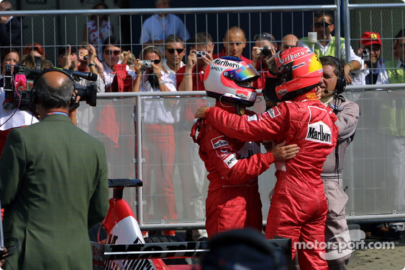 Race winner Rubens Barrichello congratulated by Michael Schumacher