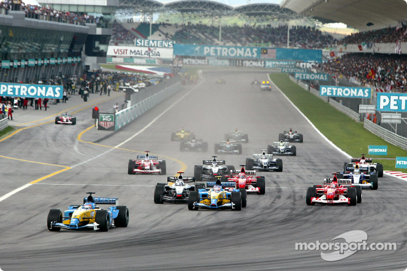 First corner: Fernando Alonso leads the field