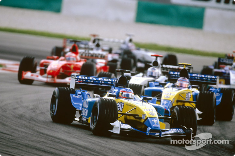 First corner: Fernando Alonso leads the field