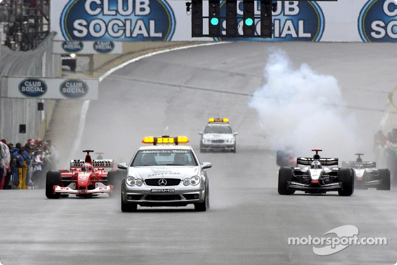 The safety car leads Rubens Barrichello and David Coulthard during the pace lap