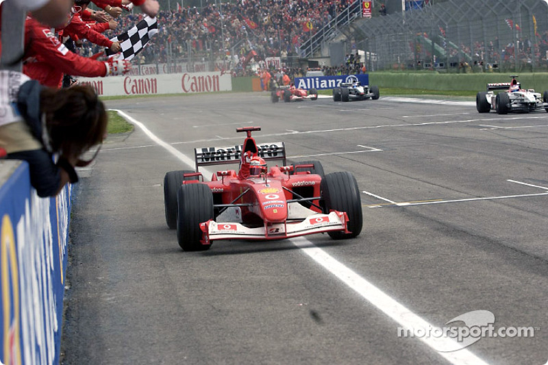 Michael Schumacher takes the checkered flag