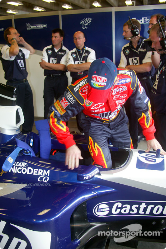 Jeff Gordon climbs into the cockpit of the FW24