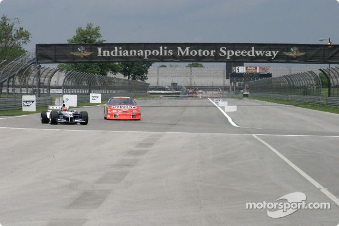 Jeff Gordon, left, and Juan Pablo Montoya veer into the left-hand turn at the end of the back straightaway at Indy