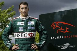 Justin Wilson poses after his transfer to Jaguar Racing from Minardi at the Jaguar Racing factory in