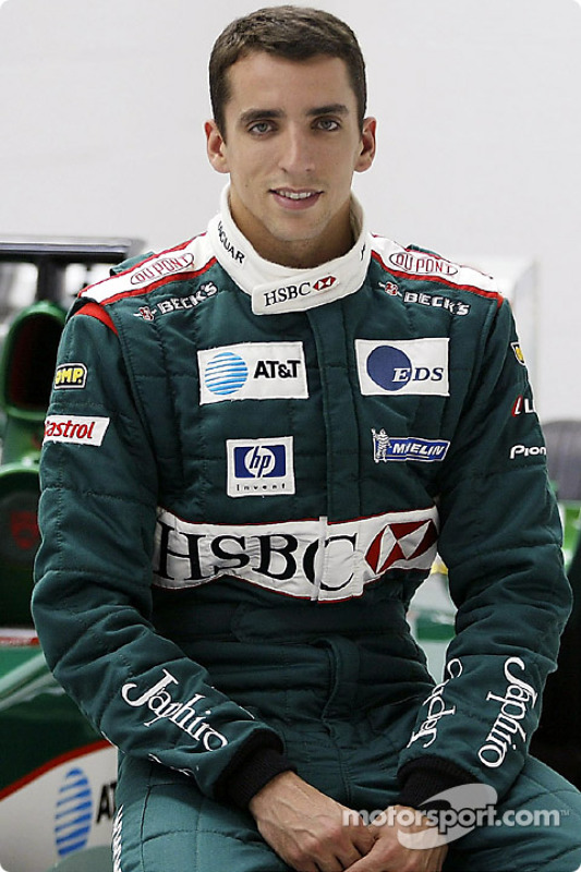 Justin Wilson poses with the Jaguar F1 car after his transfer to Jaguar Racing from Minardi at the Jaguar Racing factory in Milton Keynes