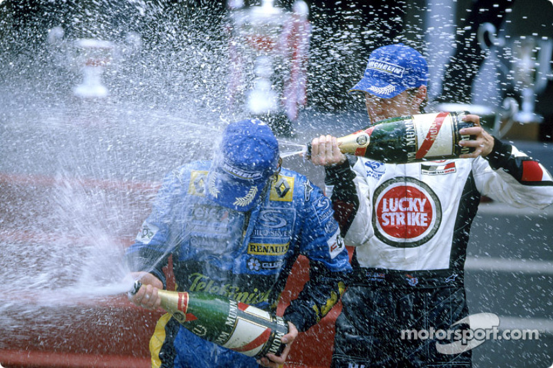 Podium: champagne for Jarno Trulli and Jenson Button