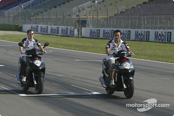 Anthony Davidson and Takuma Sato ride their Honda bike around Hockenheim