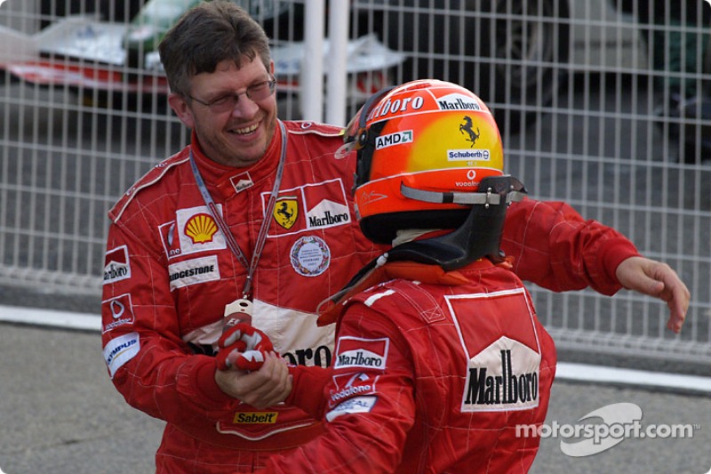 Race winner Michael Schumacher celebrates with Ross Brawn