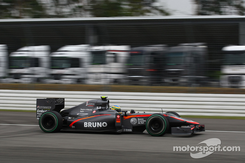 Bruno Senna, Hispania Racing F1 Team passing lorries that would normally be in the paddoc