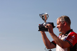 Adrian Burgess takes the trophy for the winning team