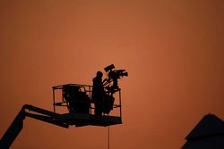 A television camera man at sun set.