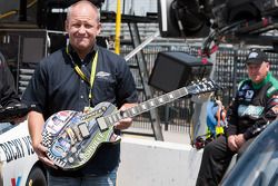 Sam Bass holds the Gibson guitar trophy that he painted for the Nashville 300 race