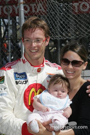 Pole winner Sébastien Bourdais celebrates with wife Claire and daughter Emma