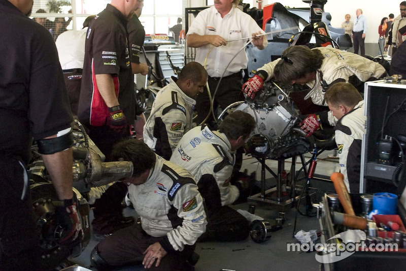 Los miembros del equipo Minardi Team USA reemplazan el embrague en el coche de Robert Doornbos