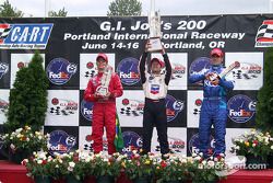 The podium: race winner Cristiano da Matta with Bruno Junqueira and Dario Franchitti