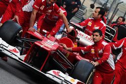 Ferrari F2012 pushed to scrutineering by mechanics