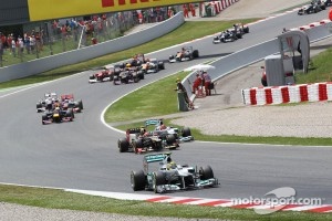 Nico Rosberg, Mercedes AMG F1 leads a battling Romain Grosjean, Lotus F1 and Michael Schumacher, Mercedes AMG F1 at the start of the race