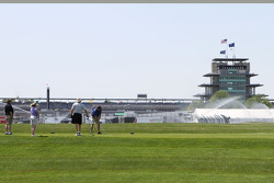 Golfers tee off with the Pagoda in the background during practice for the Indianapolis 500