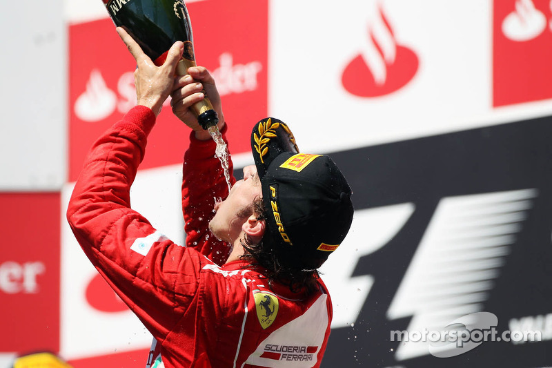 Race winner Fernando Alonso, Ferrari celebrates on the podium