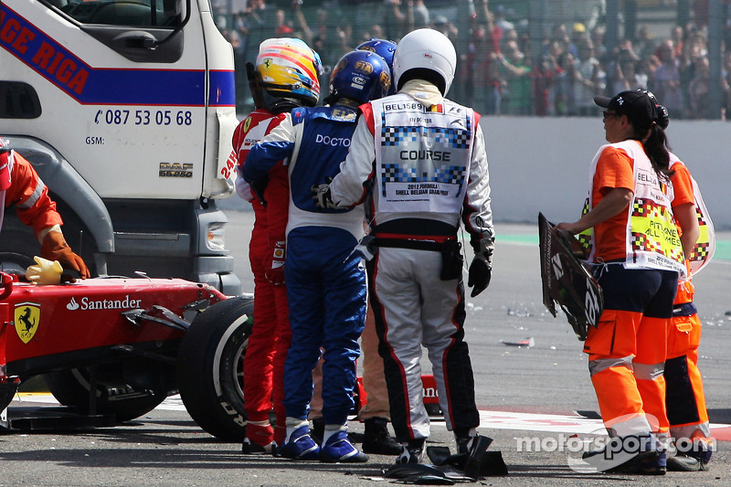 Fernando Alonso, Ferrari es ayudado de su coche después de un accidente al comienzo