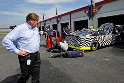 Robin Pemberton, vice president for competition of NASCAR, looks on in the garage area