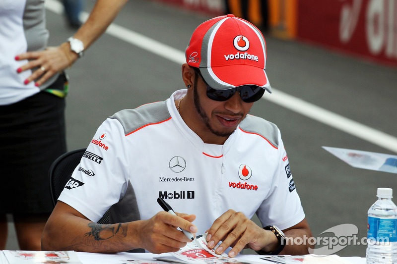 Lewis Hamilton, McLaren Mercedes, with new tattoo, signs autographs for the fans