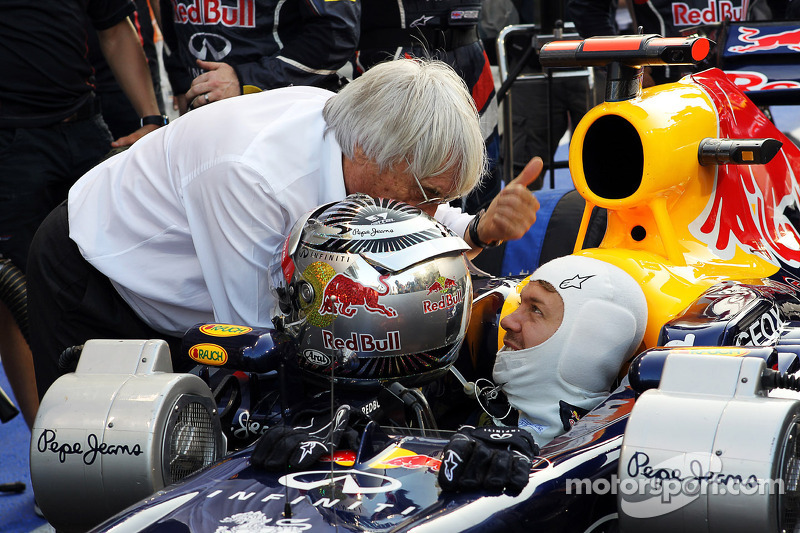 Sebastian Vettel, Red Bull Racing waits to start his race from the pit lane and talks with Bernie Ec