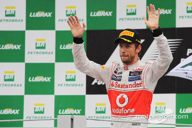 Race winner Jenson Button, McLaren celebrates on the podium