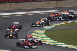Felipe Massa, Ferrari leads Jenson Button, McLaren as Sebastian Vettel, Red Bull Racing survives a crash with Sergio Perez, Sauber and Bruno Senna, Williams at the start of the race