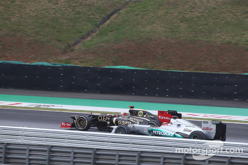 Michael Schumacher, Mercedes AMG F1 and Kimi Raikkonen, Lotus F1 battle for position