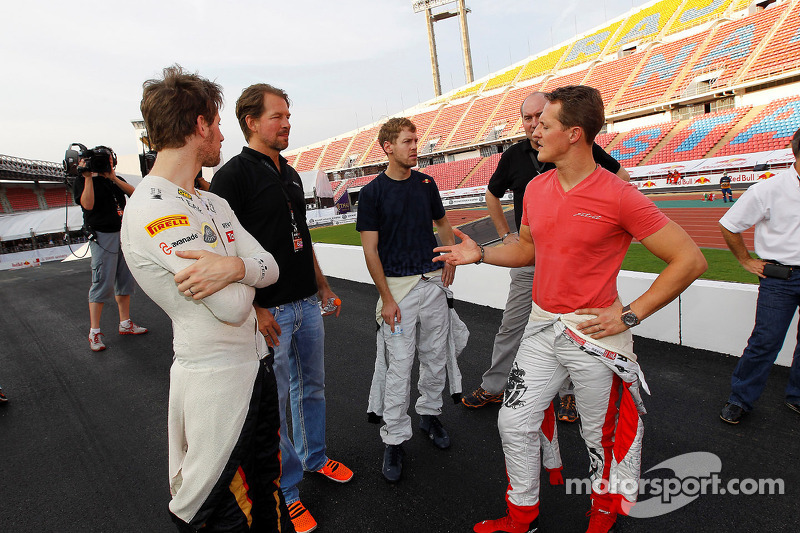 Michael Schumacher, Sebastian Vettel and Romain Grosjean watch practice