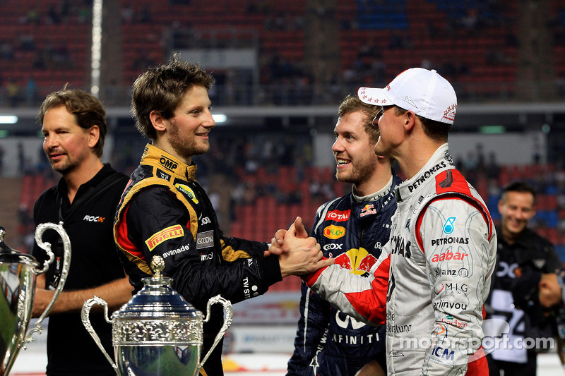 Second place Romain Grosjean and first place Michael Schumacher, Sebastian Vettel