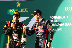 (L to R): Race winner Kimi Raikkonen, Lotus F1 Team celebrates on the podium with Sebastian Vettel, Red Bull Racing