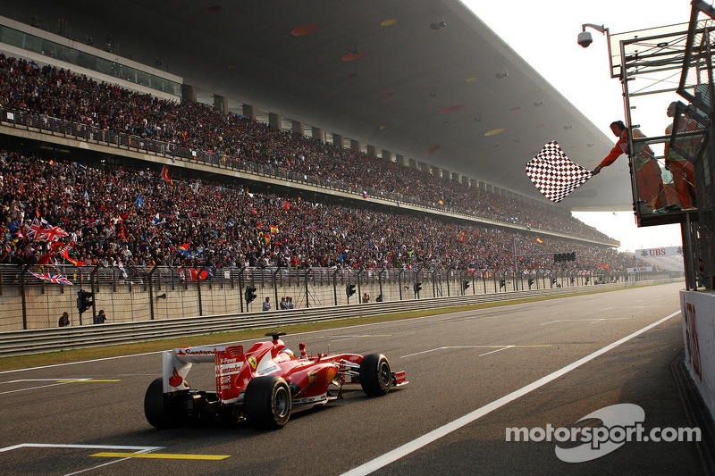 Race winner Fernando Alonso, Ferrari F138 takes the chequered flag at the end of the race