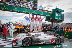 Race winners Tom Kristensen, Allan McNish and Loic Duval celebrate