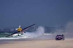 Jamie Whincup races against stunt pilot Joel Haski
