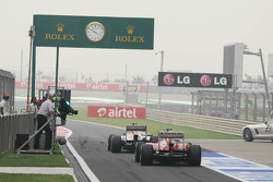 Paul di Resta, Sahara Force India VJM06 leads Fernando Alonso, Ferrari F138 out of the pits
