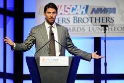 Denny Hamlin speaks onstage after winning the Coors Light Pole Award at the NMPA Myers Brothers Awards Luncheon