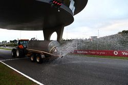The sprinkler tractor wets the track as the day is declared the official wet weather day of Pirelli tyre testing
