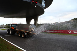 The sprinkler tractor wets the track as the day is declared the official wet weather day of Pirelli tyre testing
