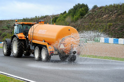 The sprinkler tractor wets the track as the day is declared the official wet weather day of Pirelli tyre testing