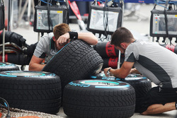 Mercedes AMG F1 mechanics prepare wet Pirelli tyres
