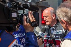 Dr. Wolfgang Ullrich addressing the media following Loic Duval's crash, reporting he was concious