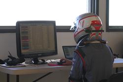 Romain Dumas checks the times on a computer at the summit