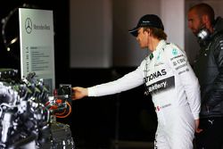 Nico Rosberg, Mercedes AMG F1 looks at a road-going Mercedes engine on display in the pits