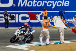 Corner workers celebrate the end of race 2