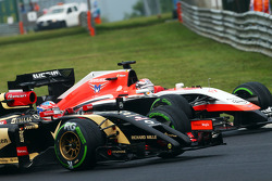 Romain Grosjean, Lotus F1 E22 and Jules Bianchi, Marussia F1 Team MR03 battle for position